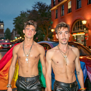 AI-generated Pride celebration art handsome men at vibrant LGBTQ+ Pride parades, embellished with rainbow colors, walking with pride, and celebrating love. By Jeff Dupler.